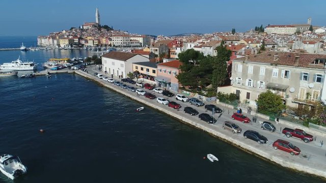 Low angle drone flight to Rovinj port and historic town, located on Istria peninsula, a popular holiday destination in Croatia