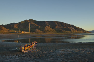 The broken down beach chair on the wasteland floor of the great salt lake. 