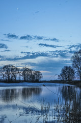 Beautiful scenery sunset on the lake in early spring.