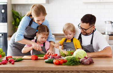 happy family with children preparing vegetable salad