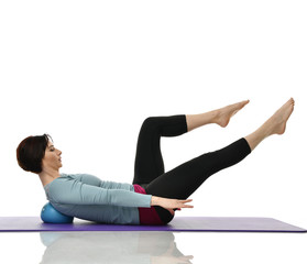 Mother woman exercising doing postnatal workout. Female fitness stretching hands and legs in gym...