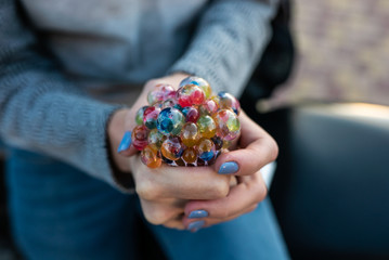 colored antistress toy in the hand of a beautiful young woman