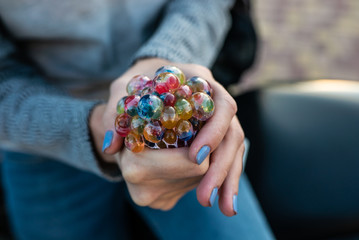 colored antistress toy in the hand of a beautiful young woman