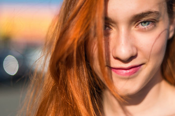 Portrait of young redhead pretty girl in outdoor