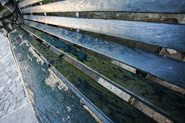 close up peeling paint on wooden bench, top view in selective focus