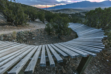 Curve of a wooden berm at sunset