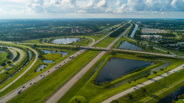 Aerial highway interchange with green grass landscape