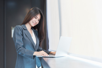 Business Woman Smiling and Working on Computer for Background.