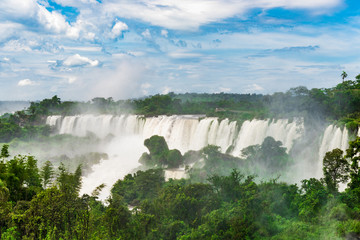 Wide angle landscape view of Iguazu falls waterfalls on a sunny day in summer. Photo taken from the Argentinian side.