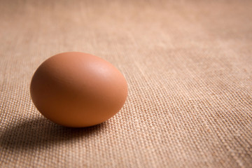 Fresh organic egg on sackcloth(gunny) with copy space for text