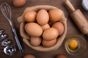 Close Up, Fresh farm eggs on a wooden rustic background, Whipping eggs and whisk,top view