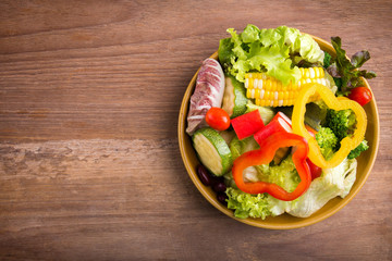 Fresh healthy salad on wood background. Weight loss. Slimming