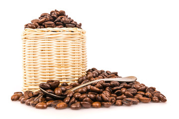Coffee beans in a wicker basket With spoon on white background