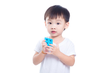 Little asian boy playing toy and looking at camera over white background