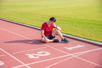 Sad asian man sitting and cry on the floor after losing in competition