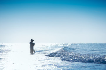 Fisherman and sea waves