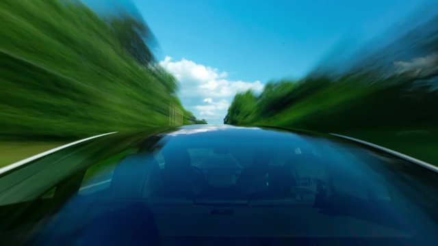 POV time-lapse of a white luxury vehicle driving down the road