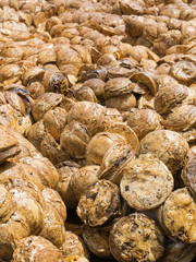 Pile of Rubber cup lump for transport to industry.Para scrap rubber nascent sun to dry.