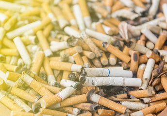 Cigarettes on smoking area.full of cigarette ends.Stop smoking concept.Anti cancer theme.