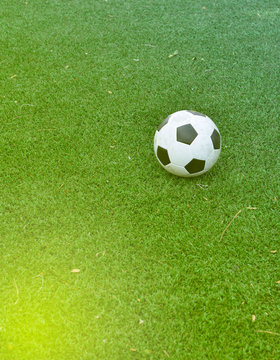 Old soccer on green field at terrain de soccer.