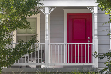 Red front door with white pillars