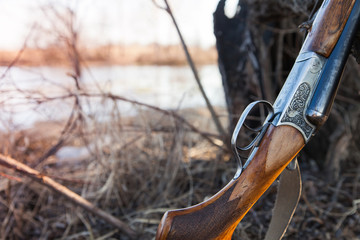 Old vintage hunting rifle on a nature background.