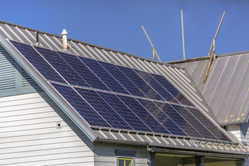Fototapeta na wymiar Solar panels on rooftop on a sunny day