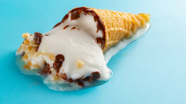 studio shoot of mini white ice cream cone melting and reverse time lapse on blue background