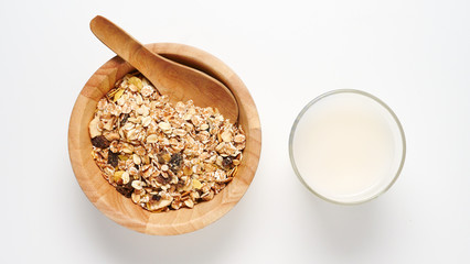 Top view of Oatmeal flakes and milk on white background.