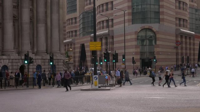 Wide shot of people crossing the street at Bank Station