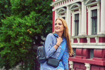 Attractive young girl on the streets of European cities .  Beautiful fashionable woman in summer...