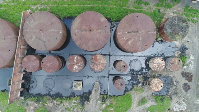 Drone shot of rusty leaking oil storage tanks in industrial zone Ostrava, Czech Republic