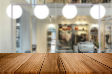 Selected focus empty brown wooden table and Coffee shop or restaurant blur background with bokeh image. for your photomontage or product display