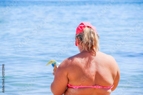 Mature Woman In Swimwear At The Sea Overweight Woman In Swimsuit Comes On The Beach Mature Woman In Swimwear At The Sea Overweight Woman In Swimsuit Comes On The Beach