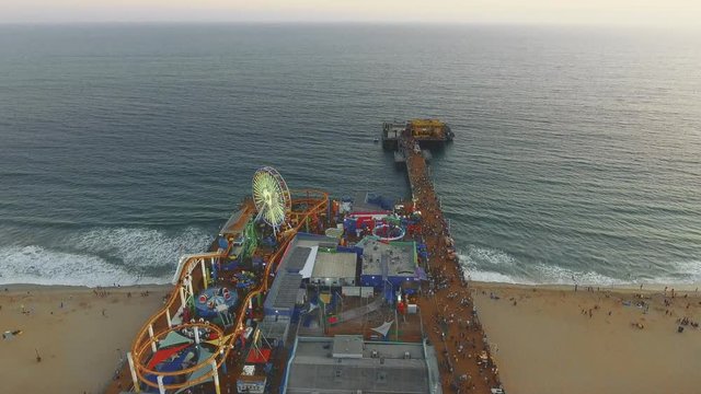 Aerial shot over Santa Monica Pier and moving towards the Ocean in California