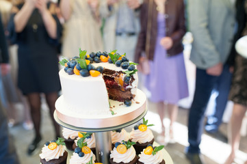 Sweet wedding cake made from fresh berry cupcake with bokeh background