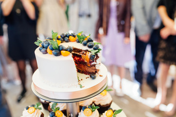 Fototapeta na wymiar Sweet wedding cake made from fresh berry cupcake with bokeh background