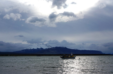 a snowed mountain and a ship