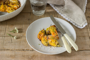 Stuffed with ricotta and cheese baked zucchini and pumpkin flowers served with a glass of mineral water. Rutik style.