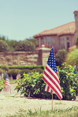 American flags displayed in honor of the 4th of July in a Texas neighborhood. Vintage toned.