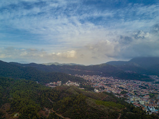 Amaizing view of Marmaris bay in cloudy day with the sun shyning through the clouds, city in the valley