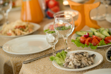 Empty plate and glass on the served banquet table