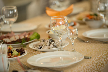 Empty plate and glass on the served banquet table