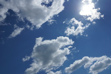 white Cumulus clouds on a blue sky background