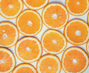 Orange slices on the white background, top view