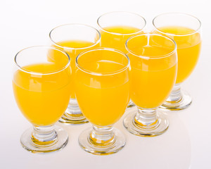 Fruit drink in glasses on white