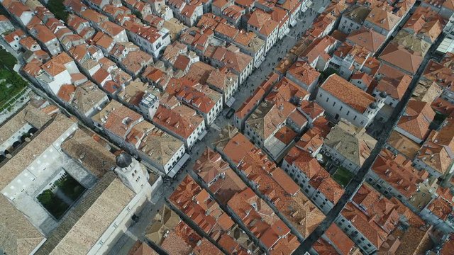 Overhead drone shot of popular main street and rooftops of beautiful historic buildings in Dubrovnik, tourism travel Croatia Europe