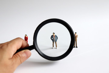 Magnifier and miniature people.
