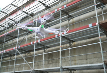 Fototapeta premium operator of the drone engineer at the construction site manages the flight and makes a video