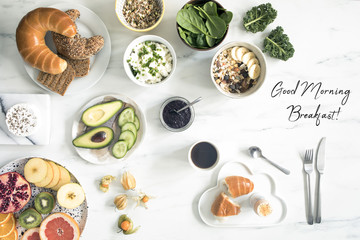 The top viev of super food on the white marble table. Flat lay. Variuos vegetables ingredients and healthy food for vegetarians. Perfect sunday morning breakfast.